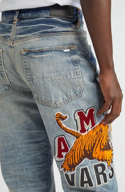 Shop Amiri Varsity Tiger Patch Embroidered Straight Leg Jeans In Vintage Indigo
