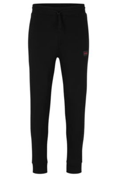 Shop Hugo Cotton-terry Tracksuit Bottoms With Red Logo Label In Black