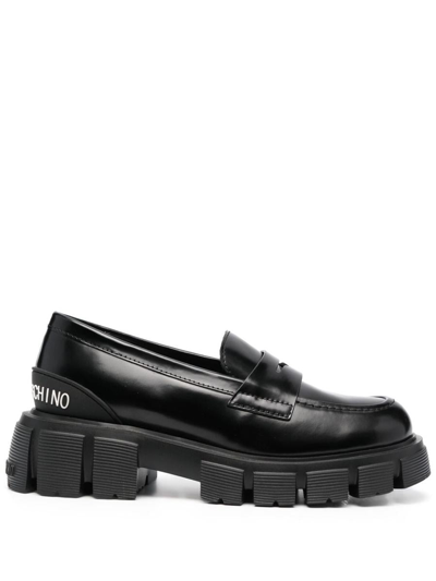 Shop Love Moschino Embossed Logo Loafers In Black