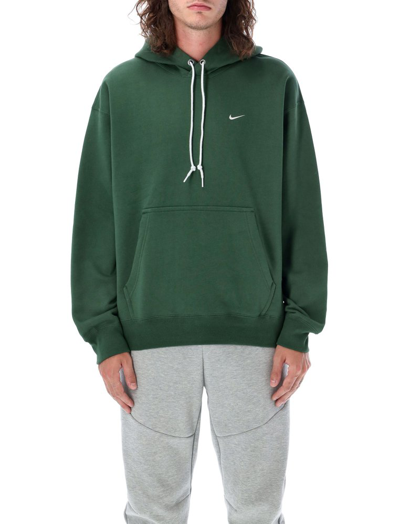Shop Nike Solo Swoosh Logo Embroidered Hoodie In Green