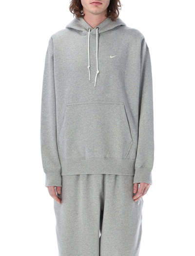 Shop Nike Solo Swoosh Logo Embroidered Hoodie In Grey