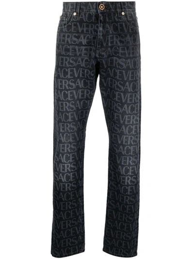 Shop Versace Logo-print Straight-leg Jeans In Black
