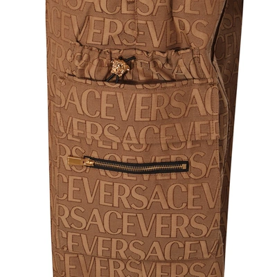 Shop Versace Trousers Beige