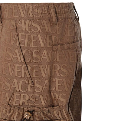 Shop Versace Trousers Beige