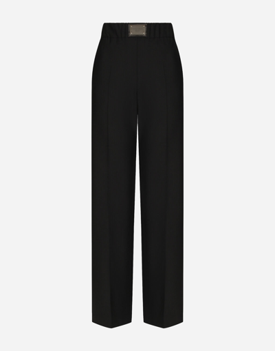 Shop Dolce & Gabbana Flared Wool Pants With Logo Tag In Black