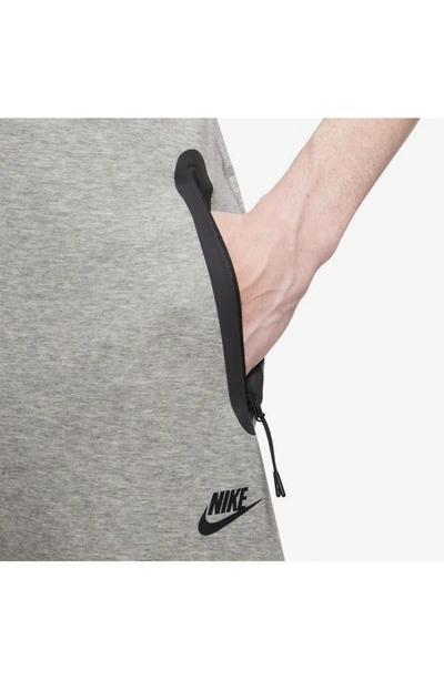 Shop Nike Tech Fleece Open Hem Pants In Dark Grey Heather/ Black