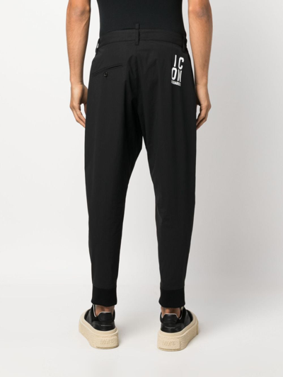 Shop Dsquared2 Icon-print Tapered-leg Trousers In Schwarz