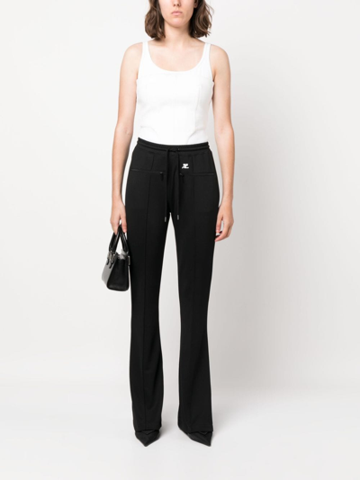 Shop Courrèges Logo-patch Drawstring Flared Trousers In Schwarz