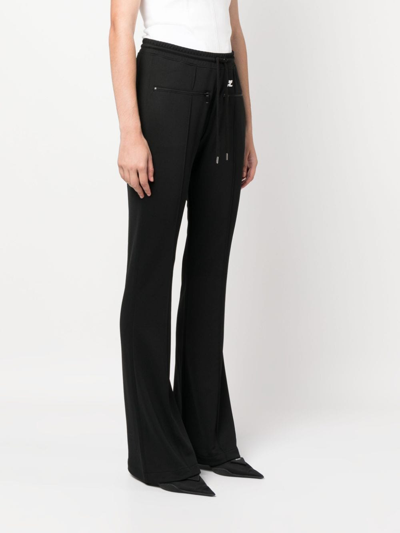 Shop Courrèges Logo-patch Drawstring Flared Trousers In Schwarz