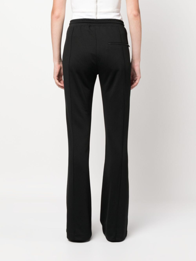 Shop Courrèges Logo-patch Drawstring Flared Trousers In Schwarz