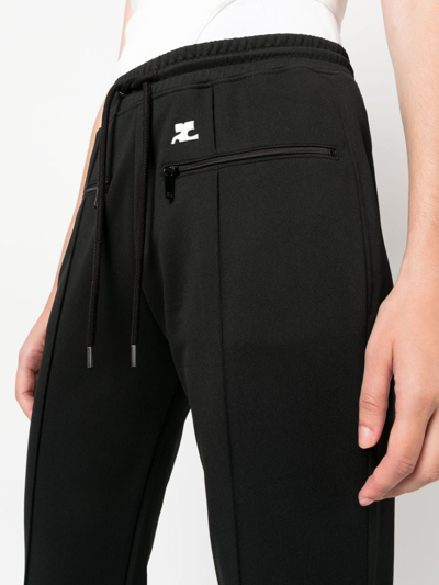 Shop Courrèges Logo-patch Drawstring Flared Trousers In Schwarz