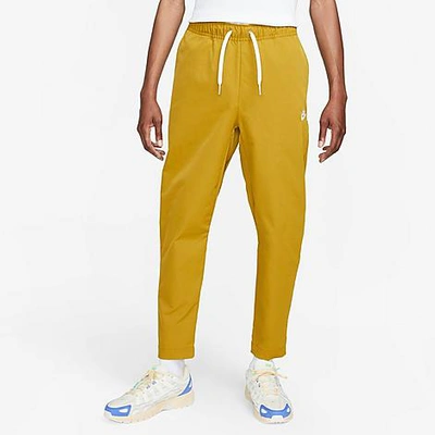Shop Nike Men's Club Woven Tapered Pants In Bronzine/white
