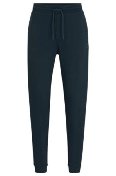 Shop Hugo Boss Cotton-terry Tracksuit Bottoms With Logo Patch In Light Green