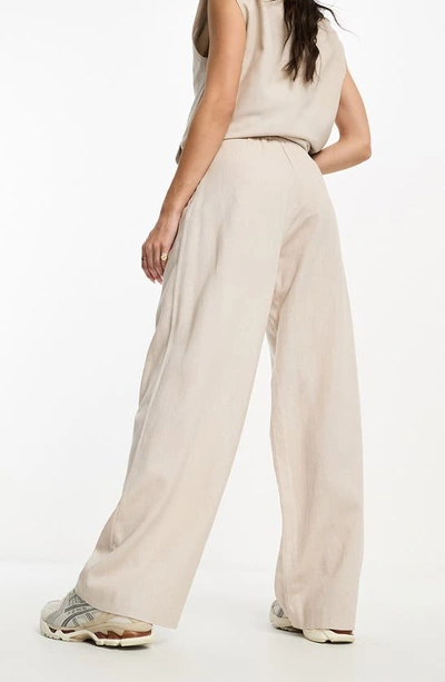 Shop Asos Design Pleated Wide Leg Suit Trousers In Beige