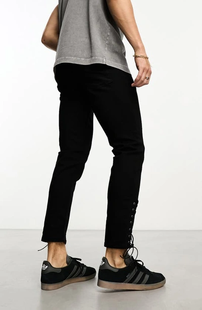 Shop Asos Design Lace-up Hem Skinny Jeans In Black