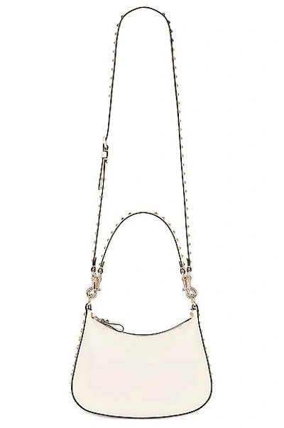 Shop Valentino Small Rockstud Hobo Zip Top Bag In Ivory