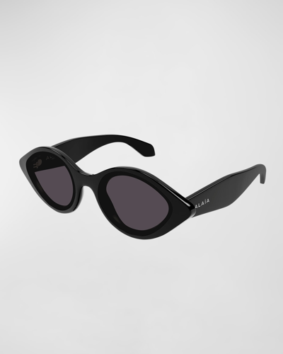 Shop Alaïa Aa0069s Elongated Acetate Round Sunglasses In Shiny Solid Black