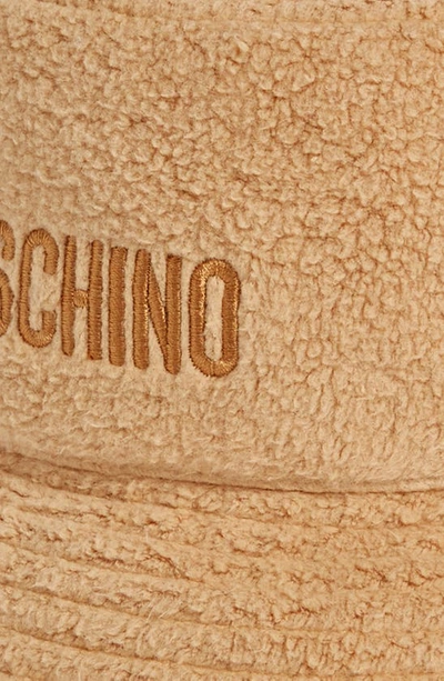 Shop Moschino Logo Embroidered Teddy Fleece Bucket Hat In 1018 Fantasy Print Beige