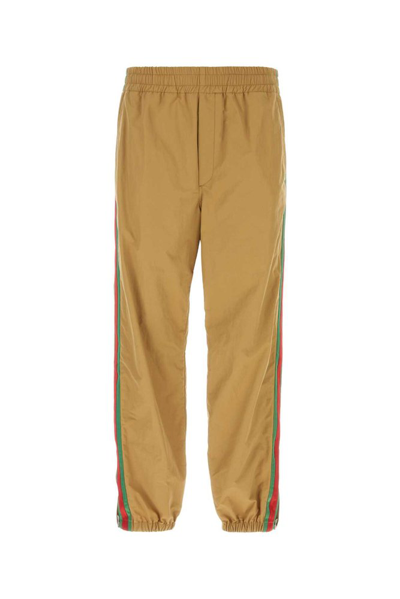 Shop Gucci Logo Embroidered Tapered Pants In Beige