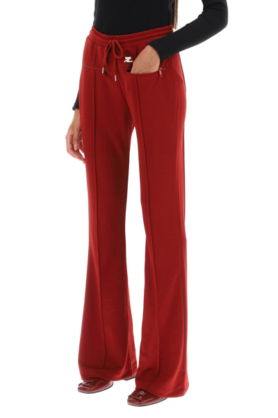 Shop Courrèges Flared Track Pants In Red (red)