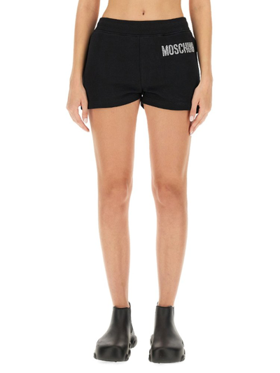 Shop Moschino Logo Embellished Shorts In Black