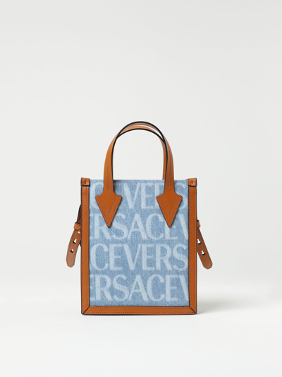 Shop Versace Denim Bag With All-over Logo