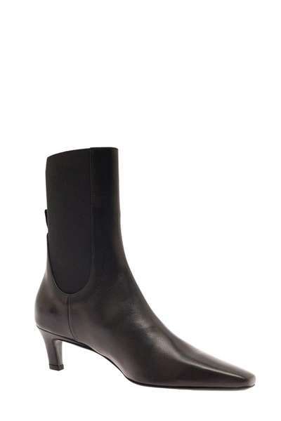 Shop Totême The Mid Heel Leather Boot In Black
