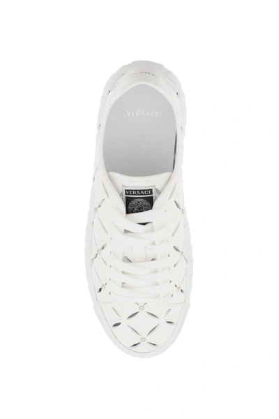 Shop Versace Greca Cut-out Sneakers In White