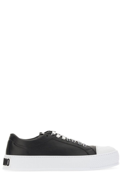 Shop Moschino Logo Embossed Round Toe Sneakers In Black
