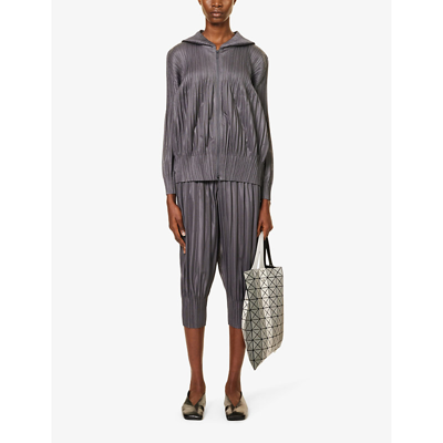 Shop Issey Miyake Pleated Tapered-leg Mid-rise Knitted Trousers In Gray