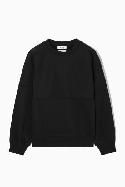 Shop Cos Oversized Exposed-seam Sweatshirt In Black