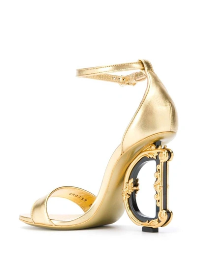 Shop Dolce & Gabbana 'baroque' Gold Colored Sandals With Logo Heel In Leather Woman In Metallic