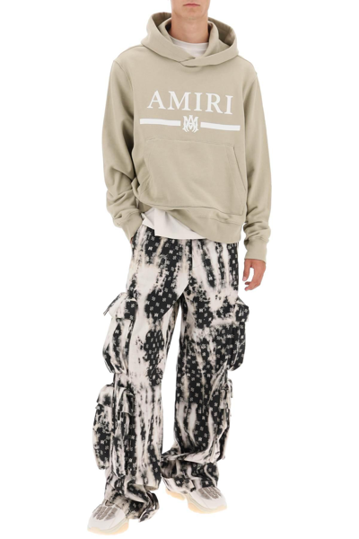 Shop Amiri Bleached Cargo Pants With Monogram Motif In Black,white