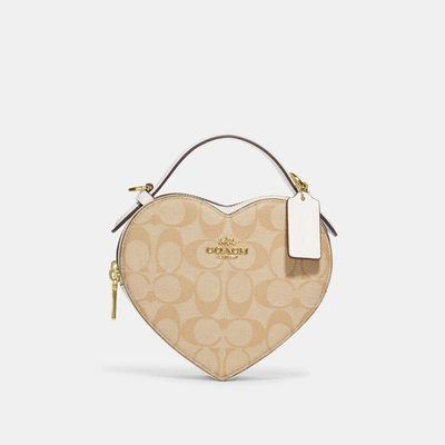 Shop Coach Outlet Heart Crossbody In Signature Canvas In Beige