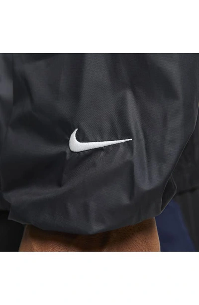 Shop Nike Storm-fit Track Club Woven Running Jacket In Black/ Midnight Navy/ White