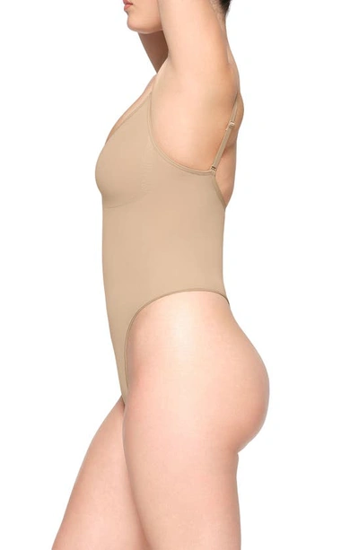 Skims Beige Seamless Sculpt Deep Plunge Thong Bodysuit In Clay