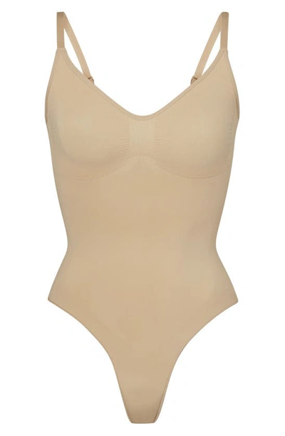 Skims Beige Seamless Sculpt Deep Plunge Thong Bodysuit In Clay