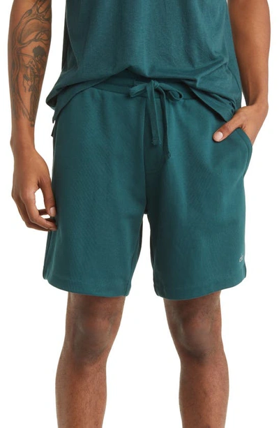 Shop Alo Yoga Chill Shorts In Midnight Green