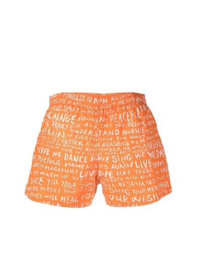 Shop Balmain Orange Slogan Print Swim Shorts
