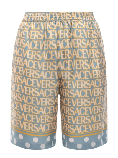 Shop Versace Silk Bermuda Shorts With All-over Logo In Multicolor