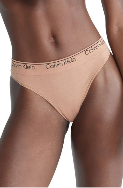 Shop Calvin Klein Naturals Modern Seamless Thong In Sandalwood