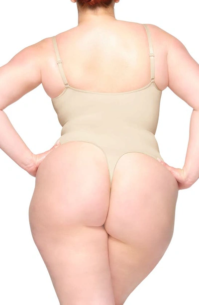 Skims Seamless Sculpt Thong Bodysuit In Sand
