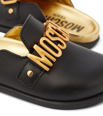 Shop Moschino Logo Leather Mules In Black