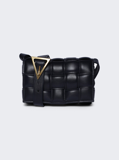 Shop Bottega Veneta Mini Cassette Crossbody Bag In Black And Gold