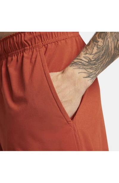 Shop Nike Dri-fit Unlimited 7-inch Unlined Athletic Shorts In Rugged Orange