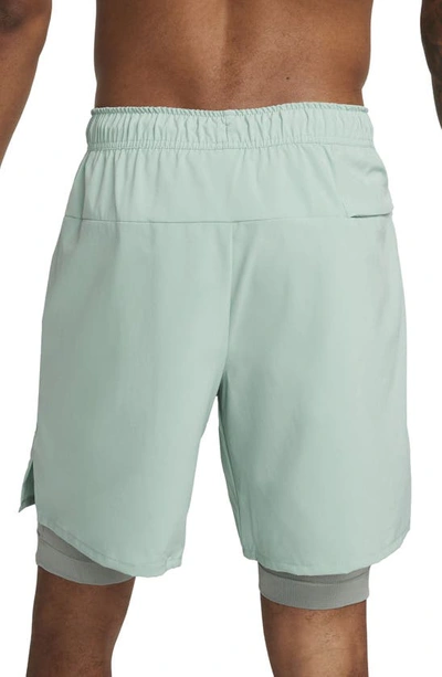 Shop Nike Dri-fit Unlimited 2-in-1 Versatile Shorts In Mineral/ Mica Green