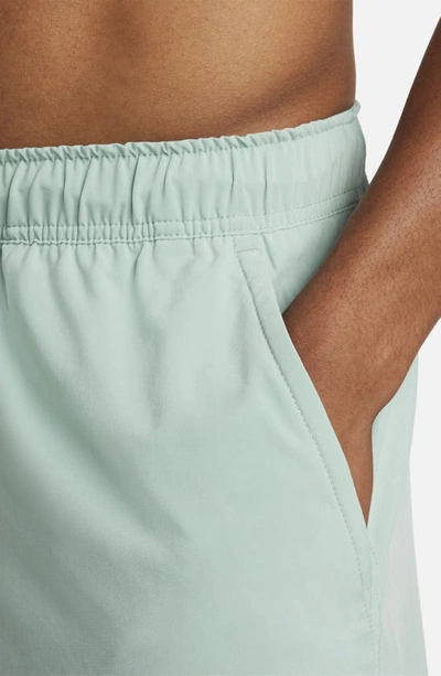 Shop Nike Dri-fit Unlimited 2-in-1 Versatile Shorts In Mineral/ Mica Green