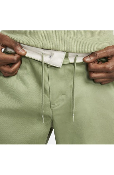 Shop Nike Life Stretch Cotton Chino Pants In Oil Green/ White