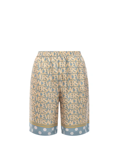 Shop Versace Silk Bermuda Shorts With All-over Logo