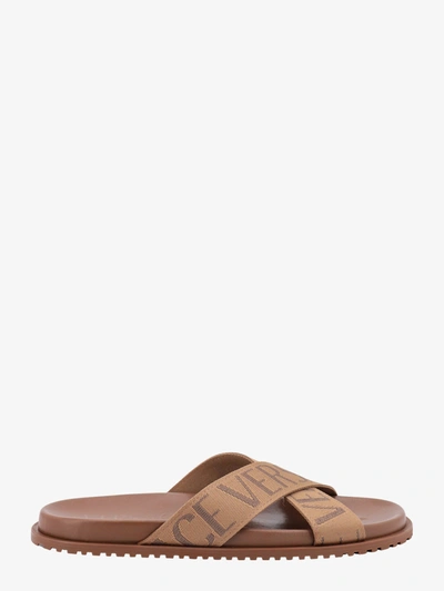 Shop Versace Rounded Toe Leather Embossed Logo Sandals In Brown